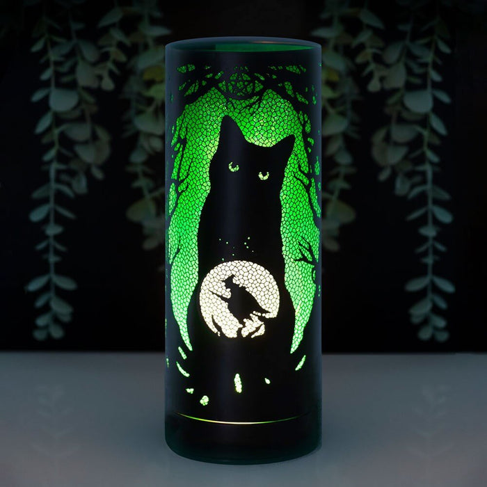 Lisa Parker artwork of black cat with crystal ball and witch silhouette, on a cylindrical aroma lamp glowing green
