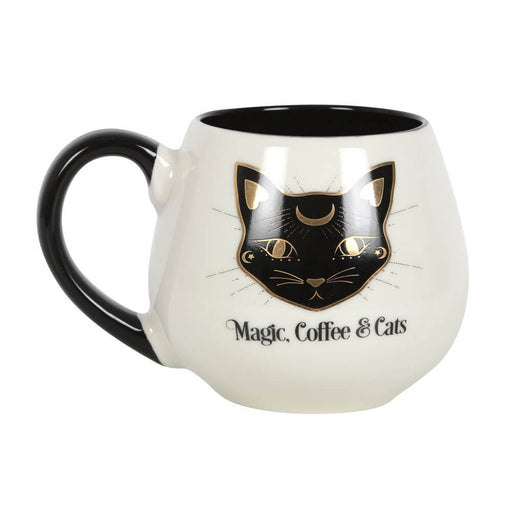 Mug with black interior and handle and white outside, with a black and gold cat face and the words "Magic, Coffee & Cats"