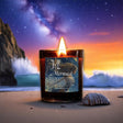 Candle labeled 'Mermaid' on a beach with a starry night sky and ocean waves in the background