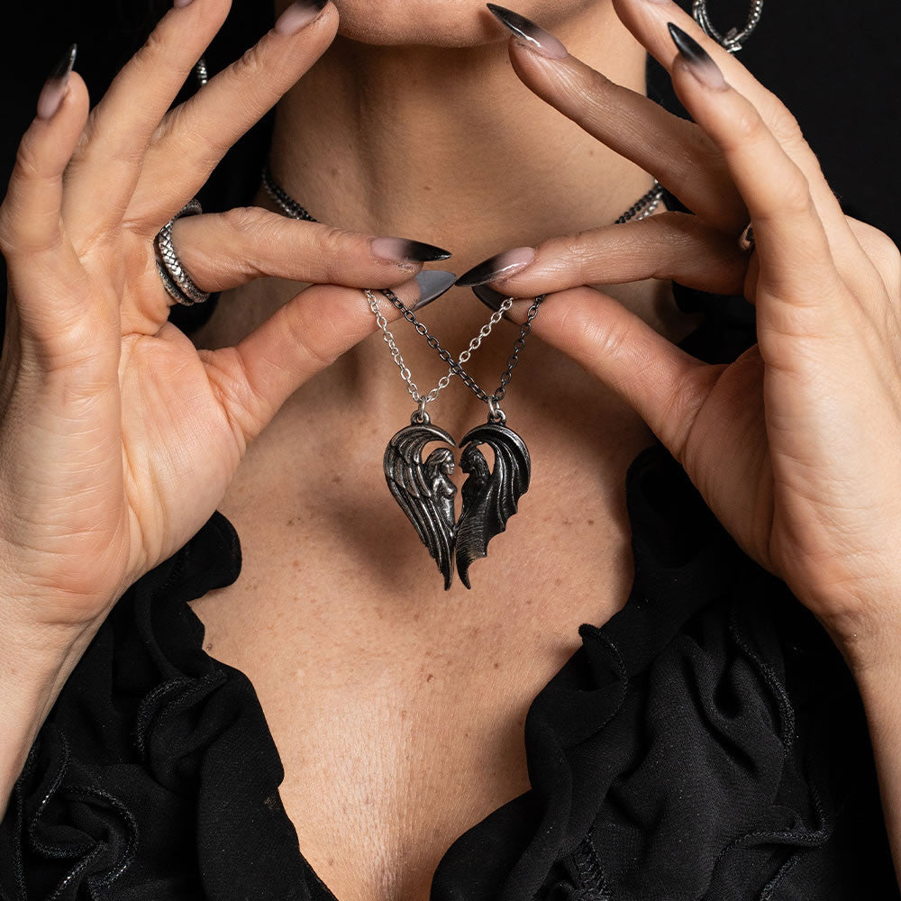 Pair of angel and demon pendants forming a heart shape, shown worn