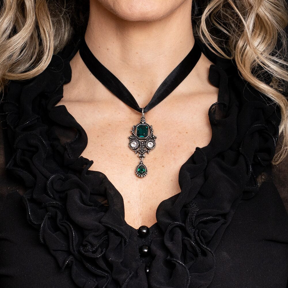 Ornate pewter necklace with green and clear gemstones, skull accent, Gothic style, shown worn on ribbon