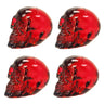 Set of four red transparent resin skulls