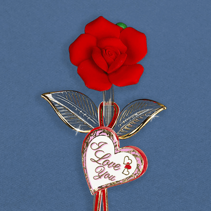 Closeup of red glass rose, gold embellished stem and leaves and tag that reads I Love You in red and pink