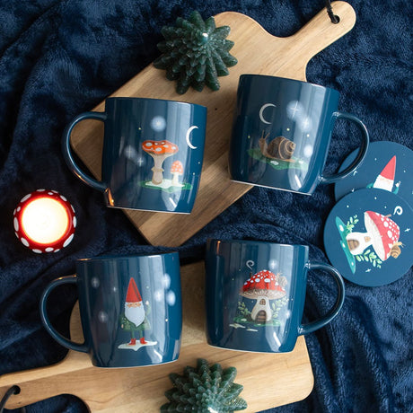 Set of 4 ceramic mugs in dark blue with snail and moon, gnome and stars, mushroom house, and mushrooms with moon.