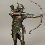 A bronze-hued figurine of Robin Hood drawing his bow with an arrow knocked