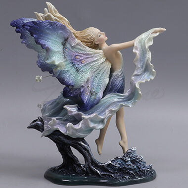 Back side view of the figurine showing colors in the wings and billowing garb