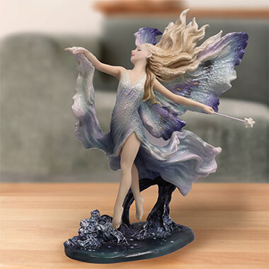 Where Moonbeams Fall fairy figurine with blond hair and blue-tipped wings, dancing with a magic wand