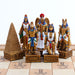 Egyptian chess set pieces showing the gold side with Sobek, Bastet, Anubis, Ra, Pyramid, and Isis on an Ankh board