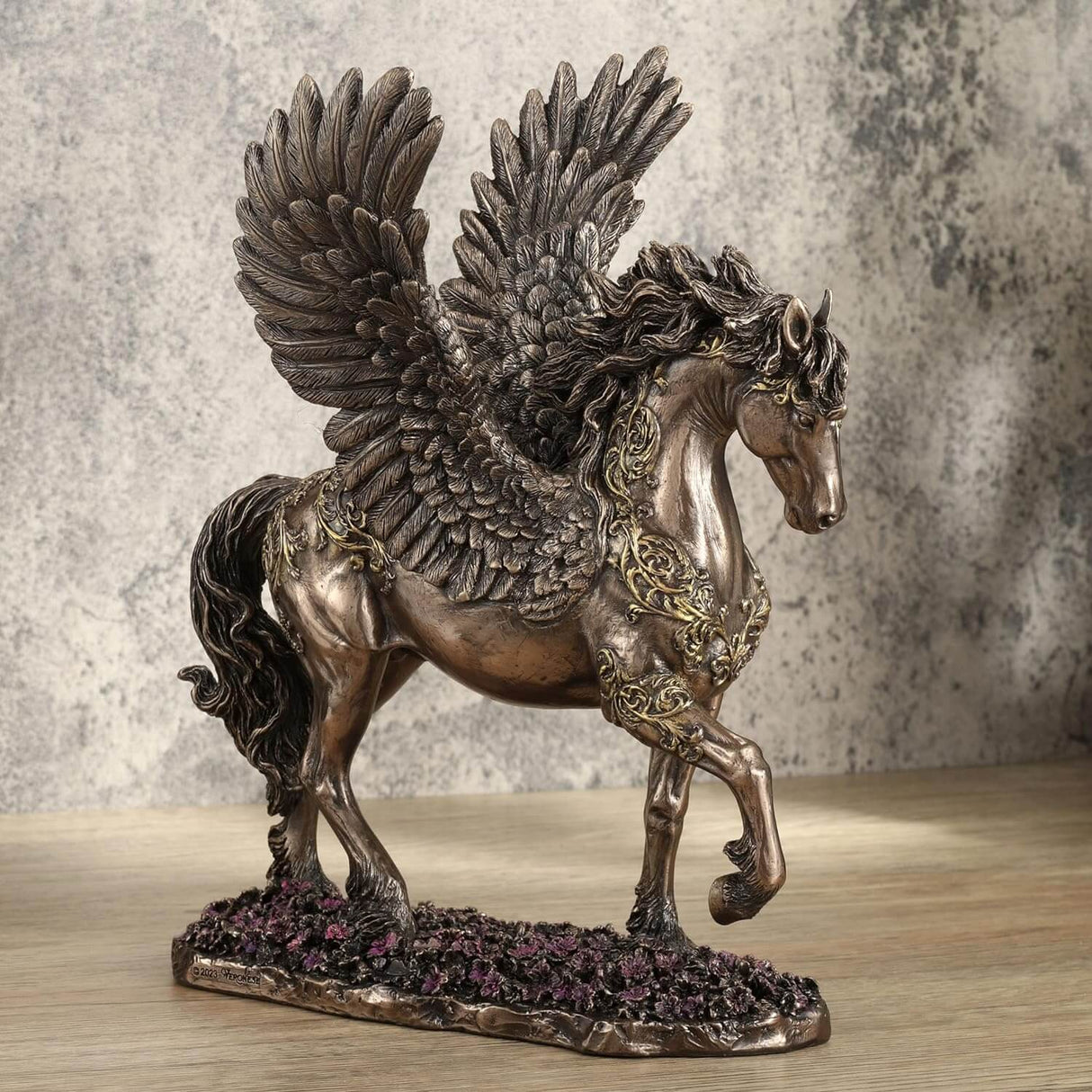 Pegasus figurine - bronze body with gold filigree designs, prancing through pink flowers