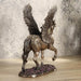 Pegasus figurine - bronze body with gold filigree designs, prancing through pink flowers