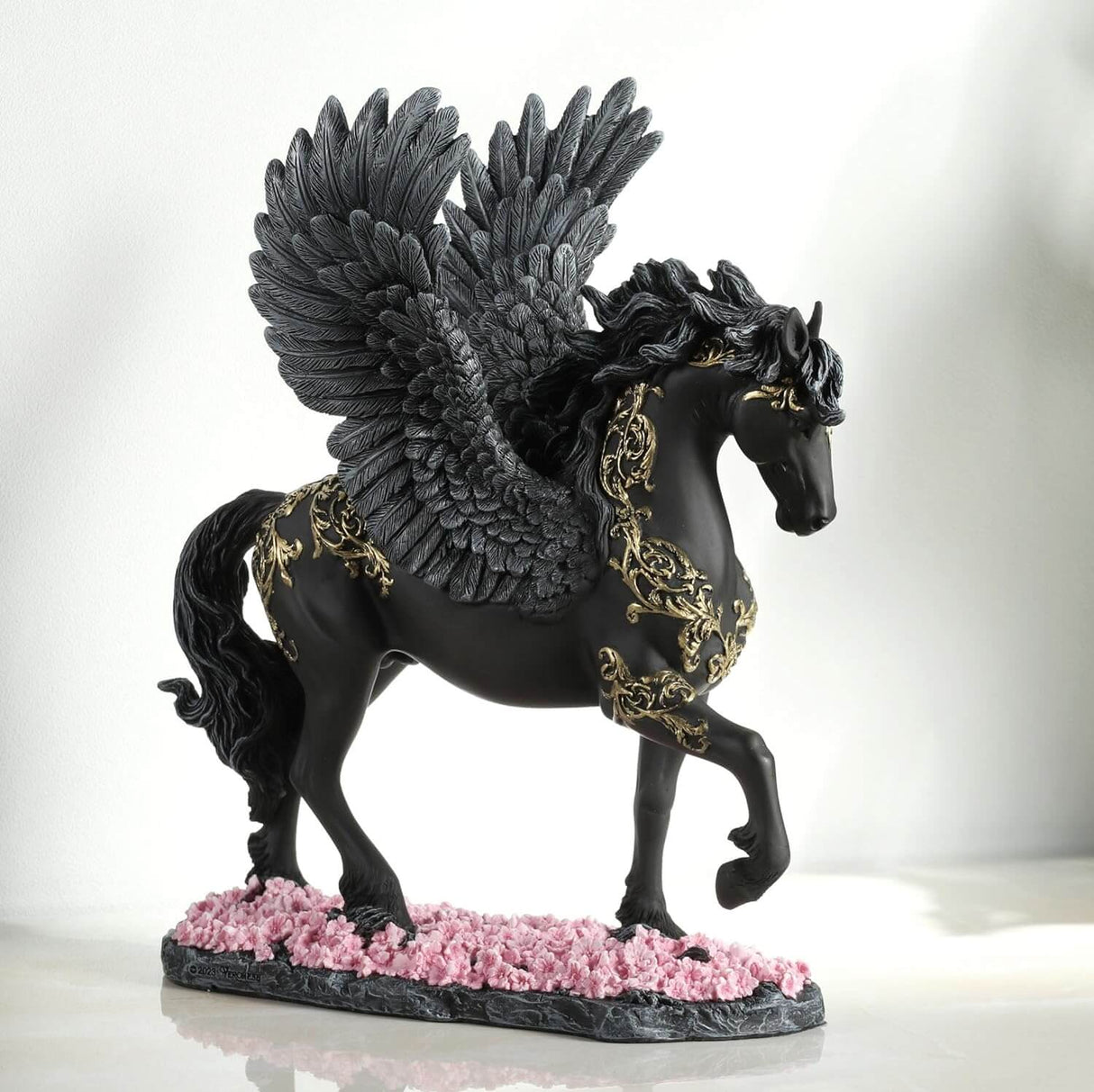 Pegasus figurine - black body with gold filigree designs, prancing through pink flowers