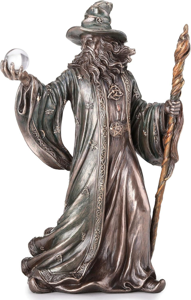 Wizard figurine holding staff and crystal ball