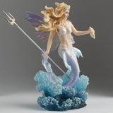 Mermaid fairy figurine with a trident and seashell bursting out of the waves