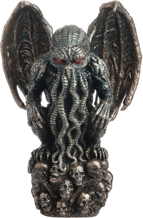 Statue of Cthulhu, winged with tentacles, crouched on a mound of skulls