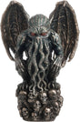 Statue of Cthulhu, winged with tentacles, crouched on a mound of skulls