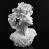 White bust of a woman with flowers for hair