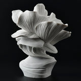 Bronze bust of a woman with flower petals for hair, in white, from the back