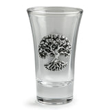 A clear glass shot glass featuring a detailed pewter tree of life emblem