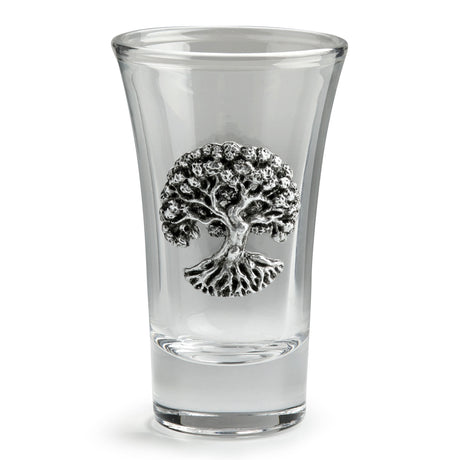 A clear glass shot glass featuring a detailed pewter tree of life emblem