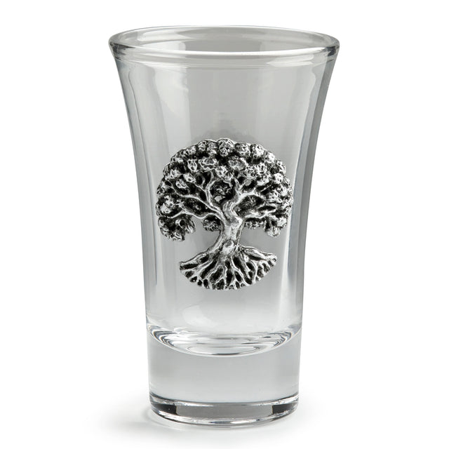 A clear glass shot glass featuring a detailed pewter tree of life emblem