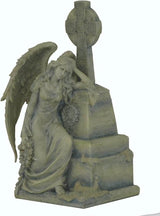 FIgurine of a gothic weeping angel leaning against an ornate gravestone with Celtic cross