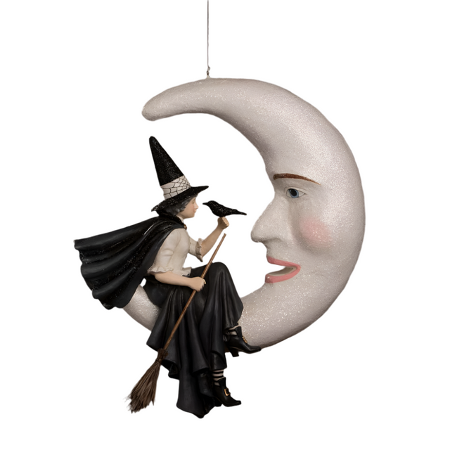 Decorative ornament of a witch on a broomstick sitting on a crescent moon with a face.