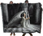 Angel tapestry blanket held up by two adults to show large size