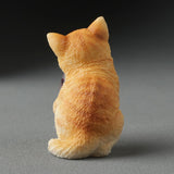 Orange cat figurine, shown from the back