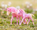 Model horse figurines, mare and foal, two appaloosa unicorns in pink and cream colors, shown in a grassy scene