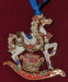 Brass rocking horse ornament with a box of toys, accented in holly and poinsettia