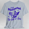 Light blue  t-shirt with purple graphic and text 'Easily Distracted By Cats & Dice'