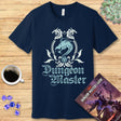 Navy blue t-shirt with 'Dungeon Master' design on a wooden surface with coffee and dice.