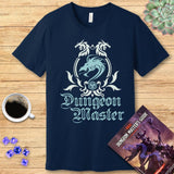 Navy blue t-shirt with 'Dungeon Master' design on a wooden surface with coffee and dice.