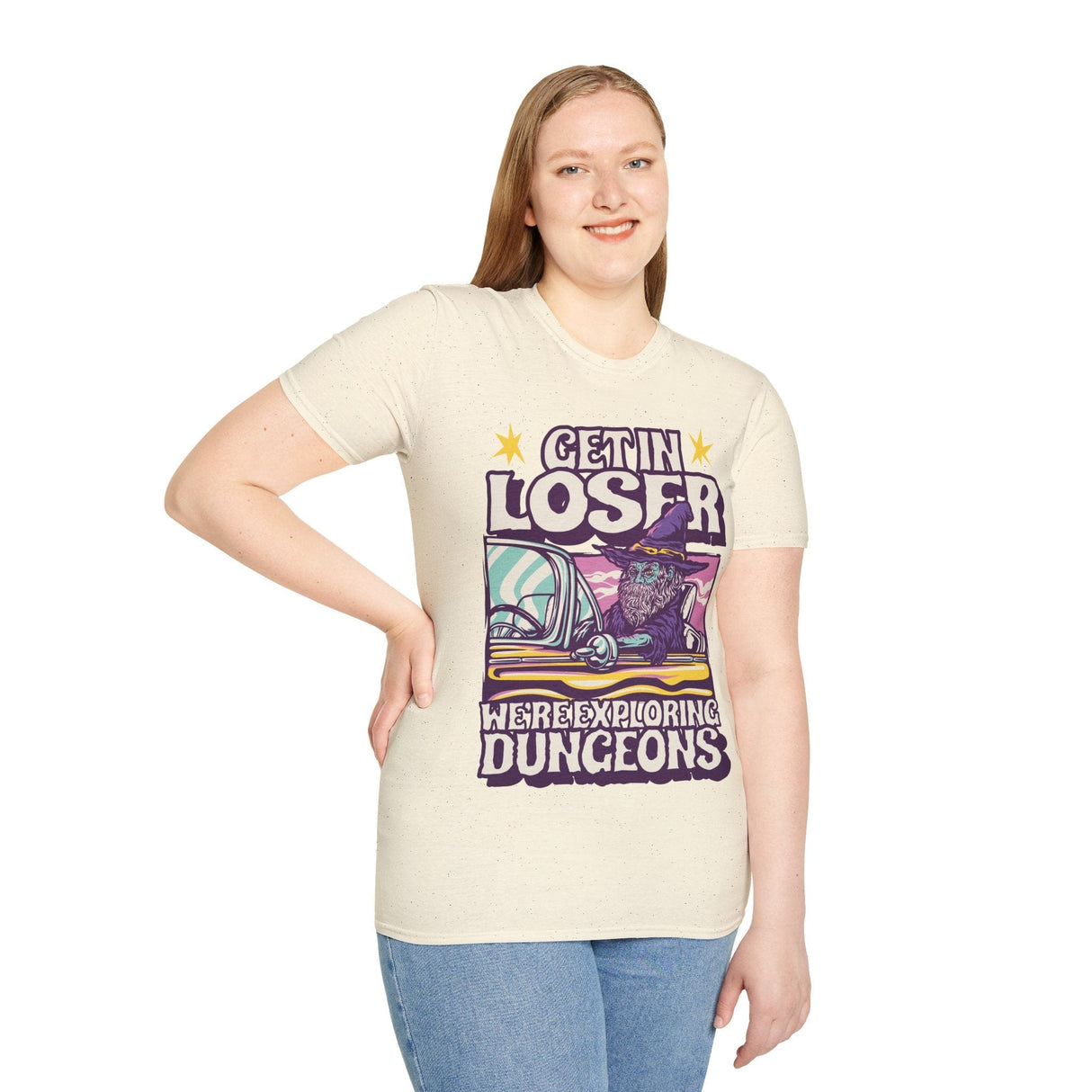 Woman wearing off white t-shirt with a graphic design featuring a wizard in a car and text 'Get in loser, we're exploring dungeons'