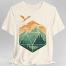 White t-shirt with a geometric dice landscape design featuring a dragon, mountains, and a castle 