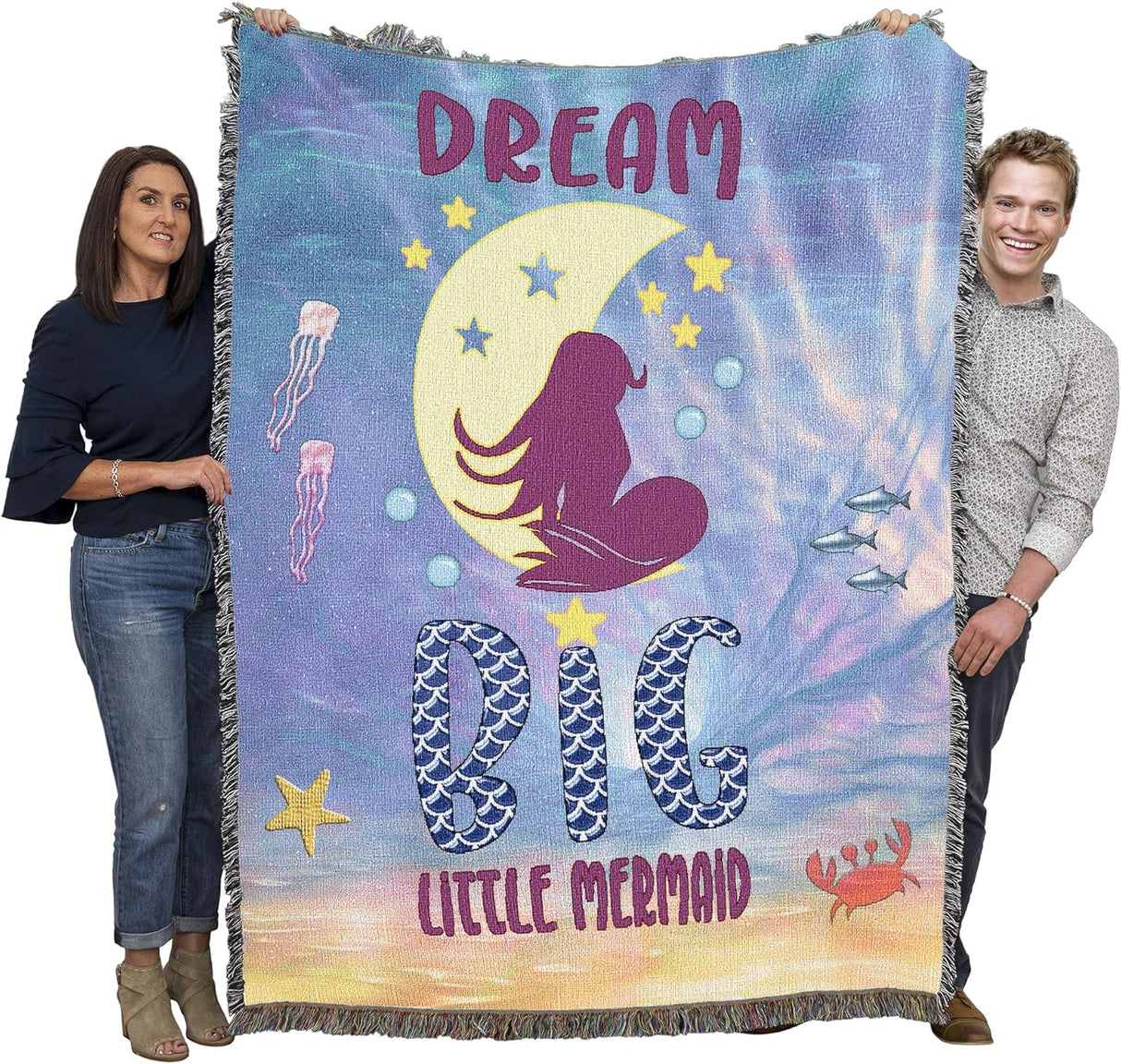 Tapestry blanket with mermaid on moon and the text "Dream Big Little Mermaid", held by two adults