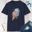 Navy blue t-shirt with ice cream cone and dice design on a wooden surface with jeans and dice.