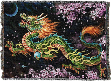 Tapestry blanket of green and orange Asian dragon with crescent moon, holding orb, cherry blossom trees around