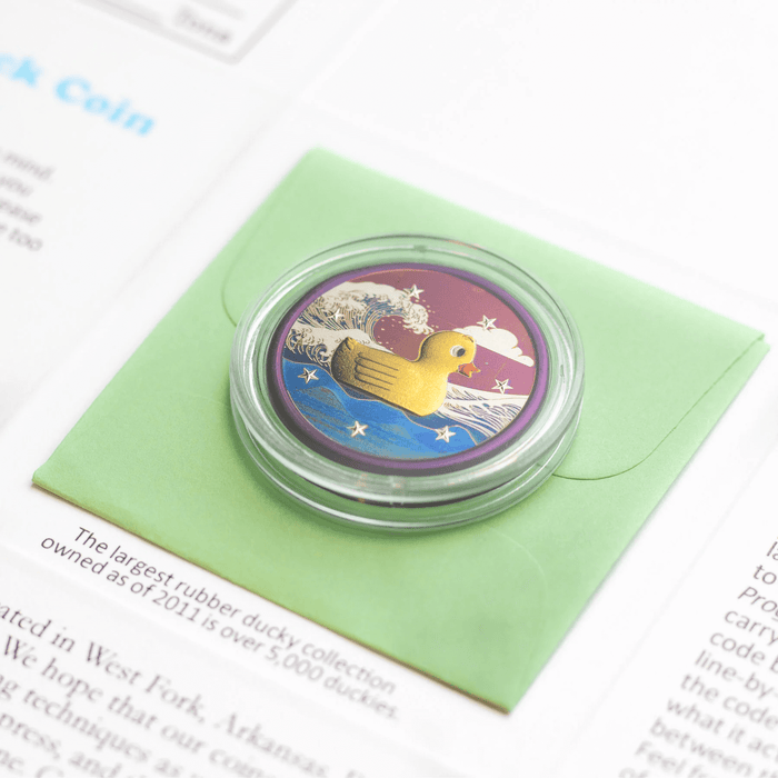 Lucky Duck collectible coin in titanium, shown duck side in archival coin capsule