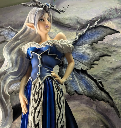 Fairy figurine with blue and silver dress and butterfly wings