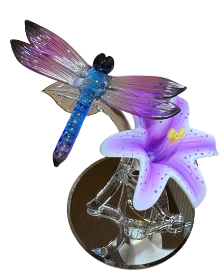 Glass dragonfly on lily