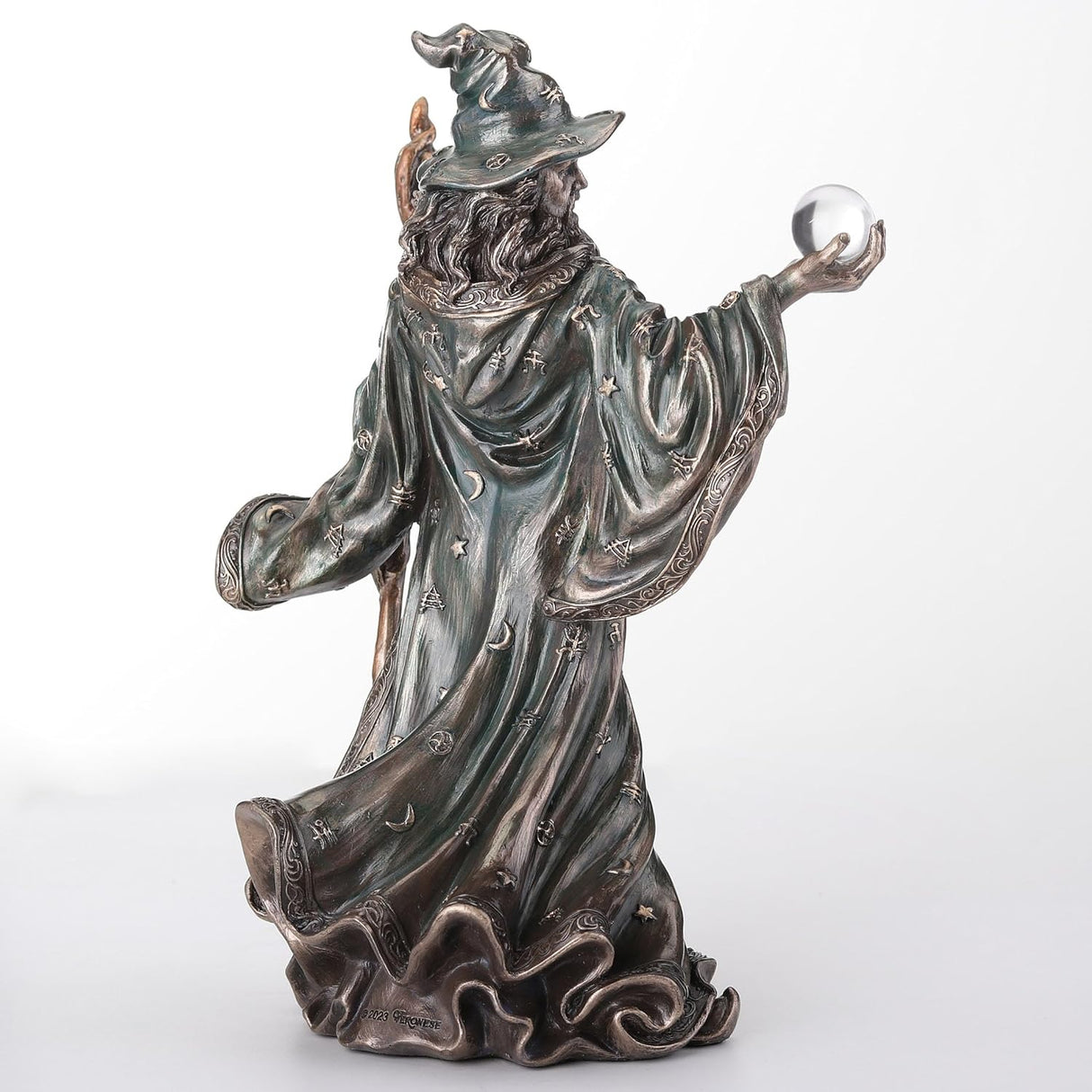 Wizard figurine holding staff and crystal ball