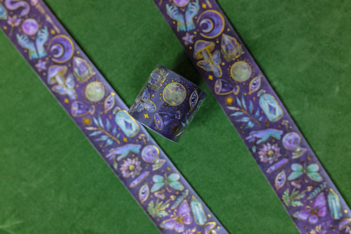 Decorative washi tape with witchy designs on purple and gold foil accents