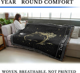 Person sitting on a couch with a decorative blanket featuring 'The Moon' design. Text around it reads, "Year Round Comfort" and "Woven. Breathable. Not Printed"