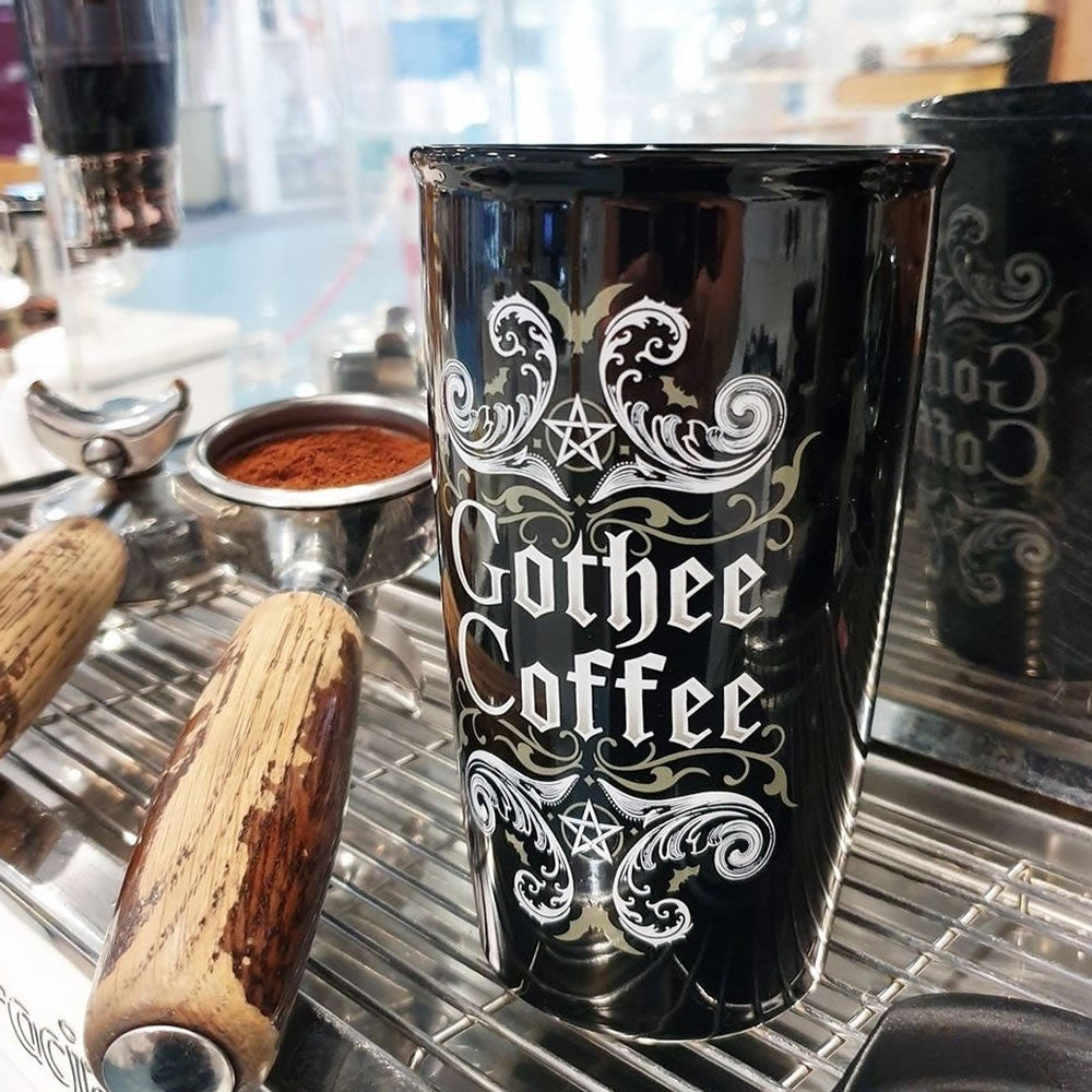 Travel mug with "Gothee Coffee" text and swirling designs with pentacles
