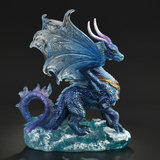 Figurine of blue dragon standing in the ocean waves