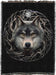 Tapestry blanket with background in black, showing wolf face at the center of a circle of tree branches with a full moon