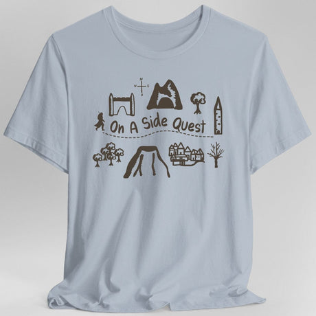Light blue t-shirt with adventuring graphics and the phrase "On A Side Quest"