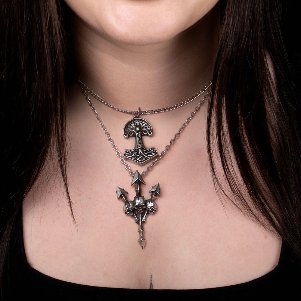 Pewter necklace with pointy trident and three skulls, shown worn 
