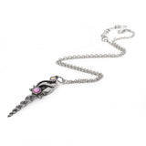 Silver pendant shaped like a unicorn horn sword with jewel accents on a chain